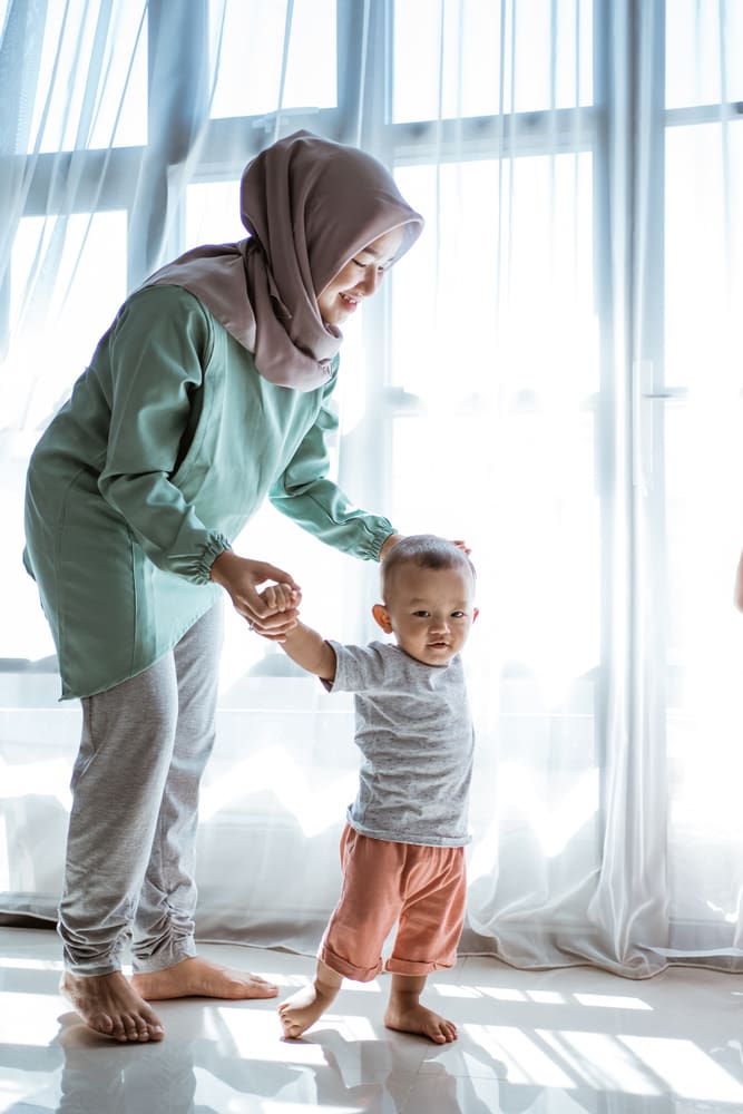 hijab mother walking with toddler